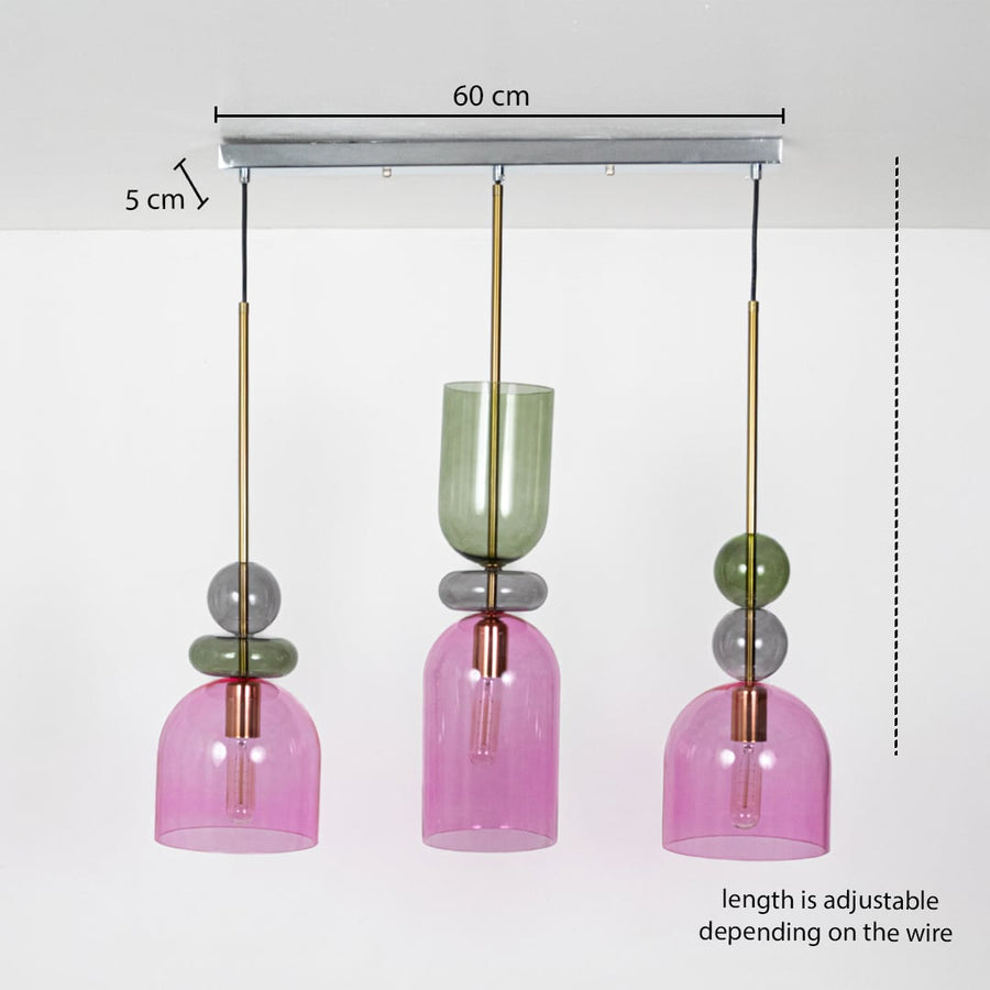 Pink and green glass pendant light trio with adjustable wire length shown with detailed measurements highlighting ideal placement for modern interiors.