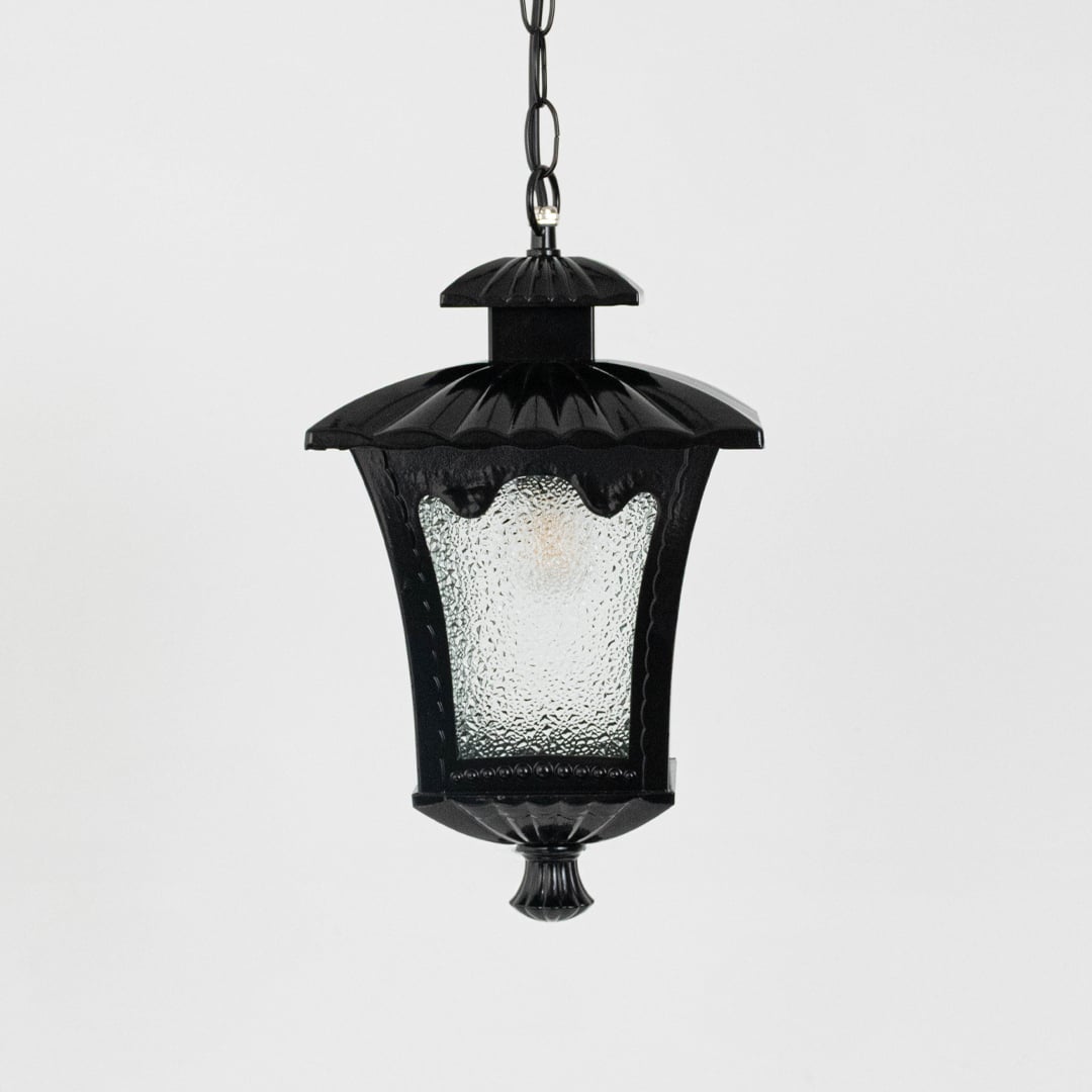 Black outdoor lantern light on white background highlighting elegant curved top and frosted glass texture.