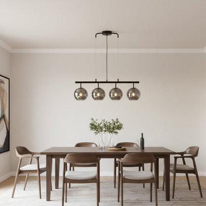 Modern black and chrome chandelier with four reflective glass globes adding luxury style and soft ambient glow to home interiors.
