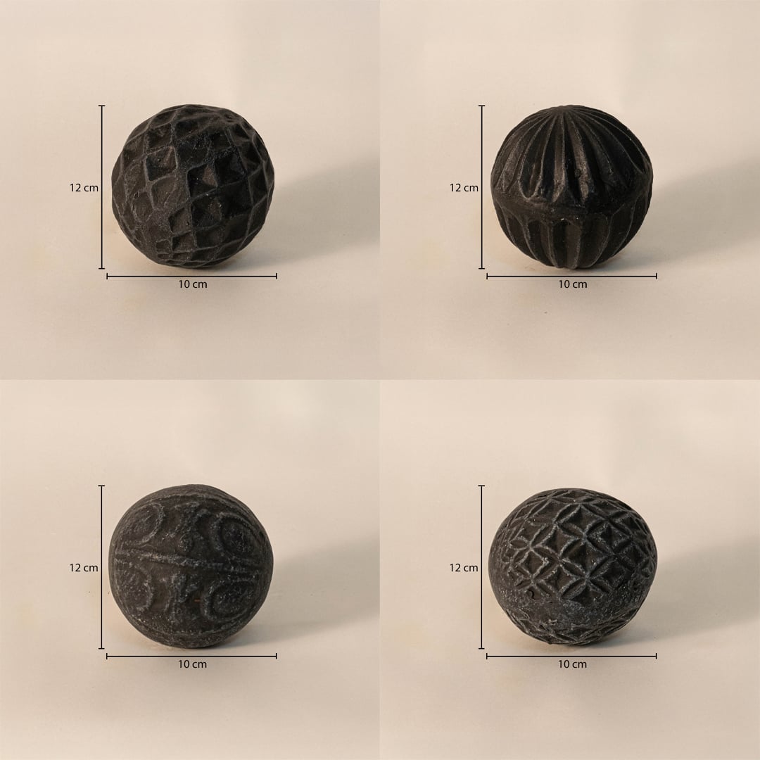 Black carved balls set - each ball measuring 12 cm in height and 10 cm in width - perfect for table or tray decor.