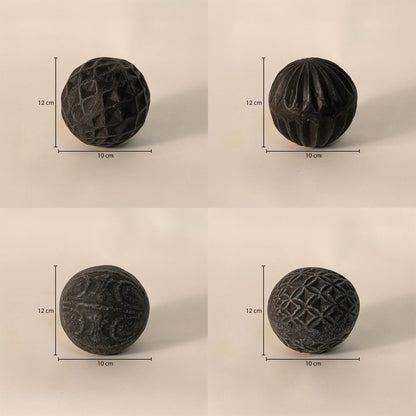 Black carved balls set - each ball measuring 12 cm in height and 10 cm in width - perfect for table or tray decor.