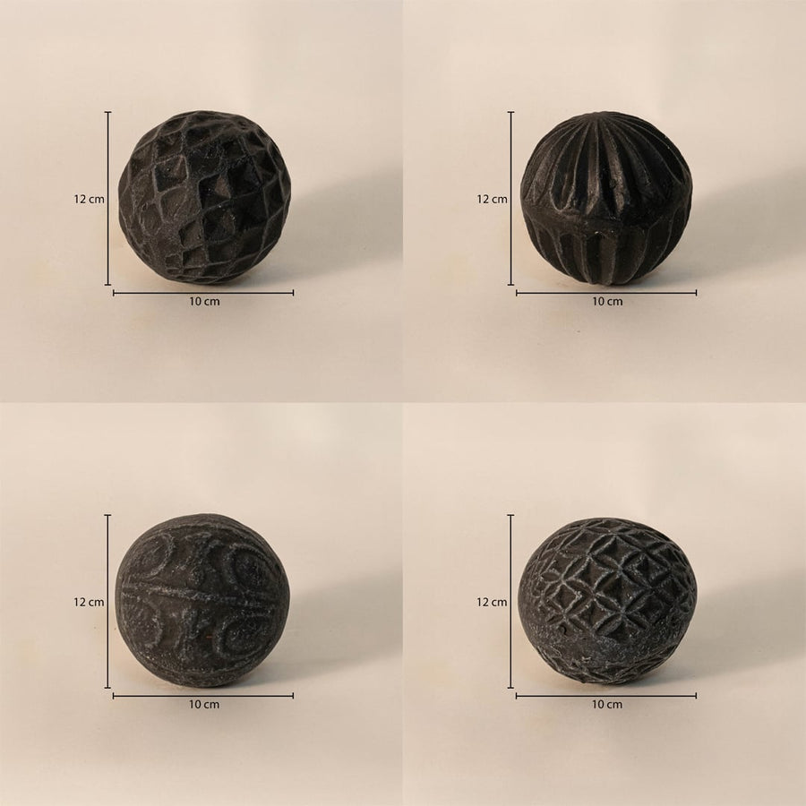Black carved balls set - each ball measuring 12 cm in height and 10 cm in width - perfect for table or tray decor.
