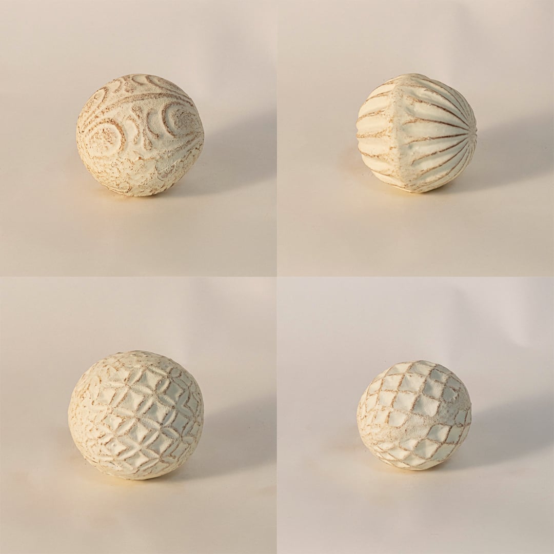 Close-up of textured ceramic ball highlighting detailed craftsmanship and soft natural clay texture.