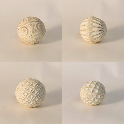 Close-up of textured ceramic ball highlighting detailed craftsmanship and soft natural clay texture.