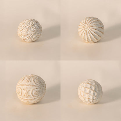Close-up of decorative carved ball revealing intricate hand-carved detailing and fine textured ceramic finish.