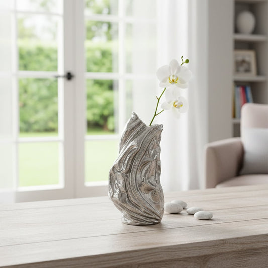 Tall silver sculptural decor object with fluid abstract form styled in modern interior statement metallic accent for console table living room or office decor.