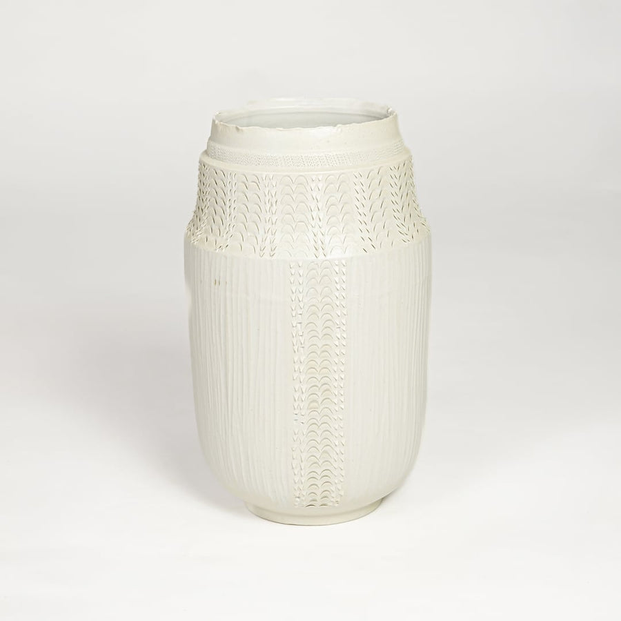 White ceramic textured vase with detailed handcrafted pattern isolated on clean white background for contemporary home decor use.