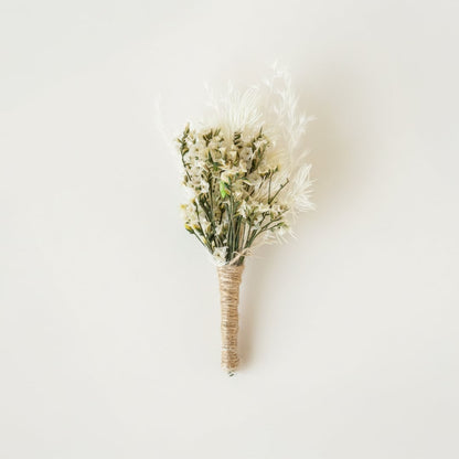 Dried floral stem bouquet with soft white blossoms and feathery textures on white background highlighting natural elegance handcrafted detail and minimal decor appeal.