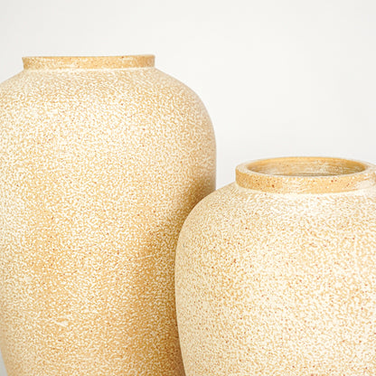 Closeup image of beige ceramic vase set for modern tabletop decor styling with rustic textured finish.