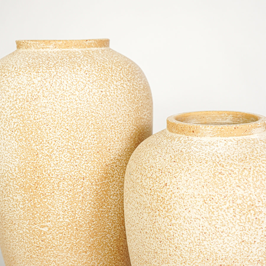 Closeup image of beige ceramic vase set for modern tabletop decor styling with rustic textured finish.