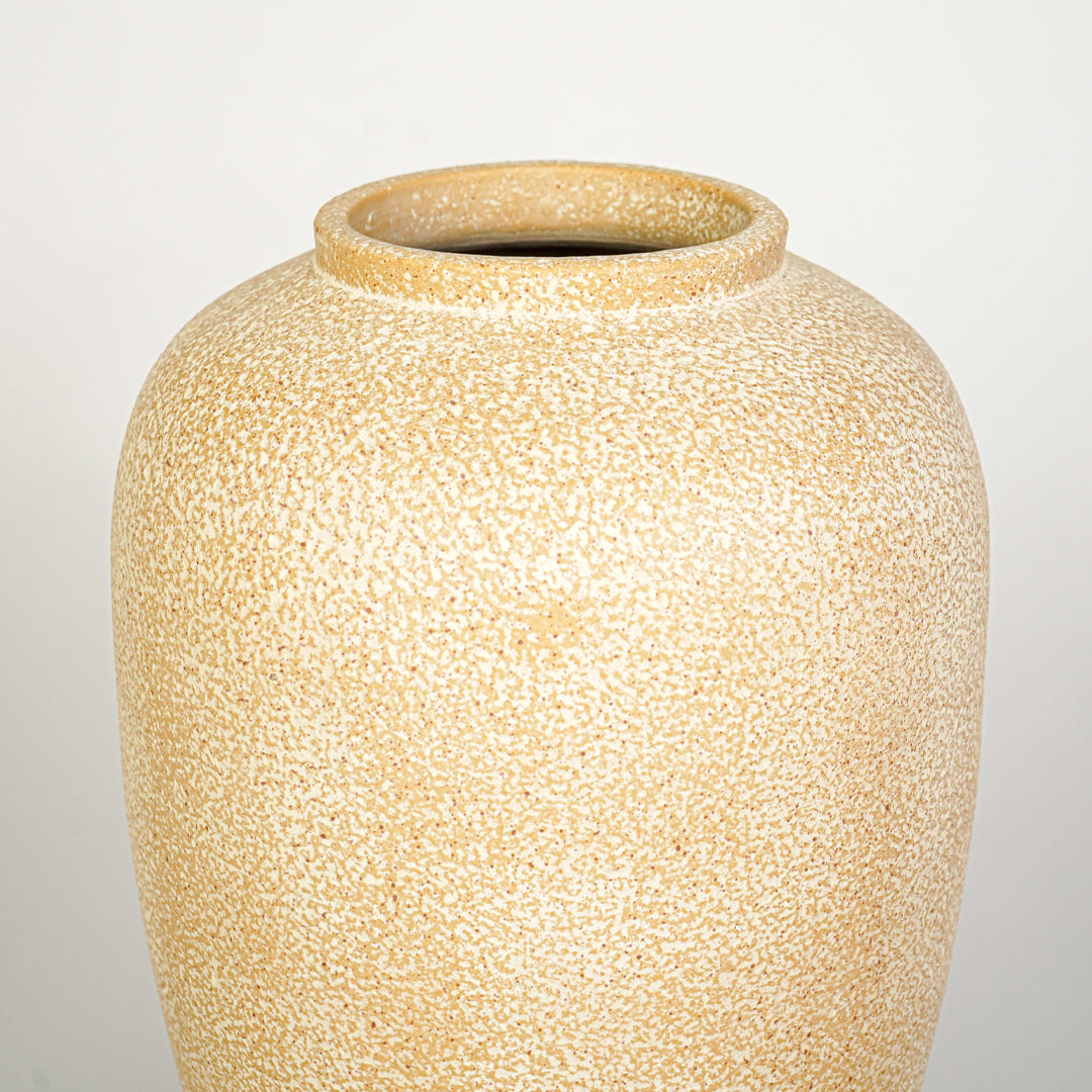 Closeup image of beige ceramic decorative vase for modern interior decor styling with textured matte finish.
