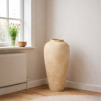 Beige textured floor vase placed in room corner for stylish contemporary living room decor styling.