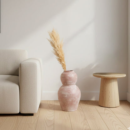 Rustic pink textured decorative vase arranged in a designed home setting adding sculptural artistic decor to living rooms entryways and styled spaces.