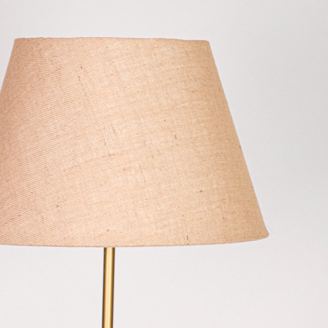 Closeup beige fabric tapered shade with natural linen texture for soft diffused lighting in elegant interior spaces Decor.