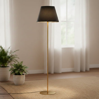 Modern gold metal floor lamp with black fabric shade placed in living room corner for warm ambient lighting Decor.