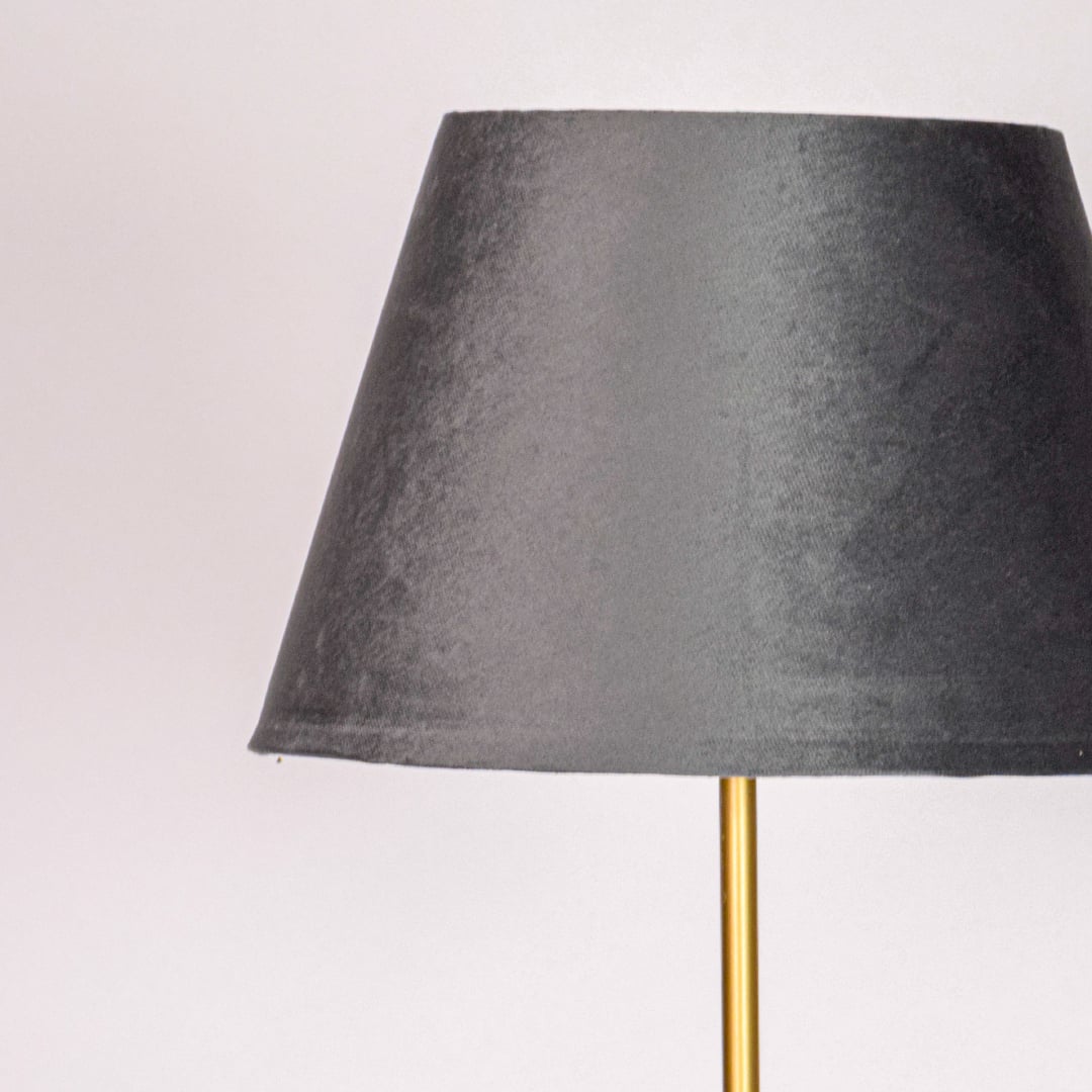 Closeup black fabric tapered shade with smooth texture designed for soft ambient lighting in modern living room Decor.