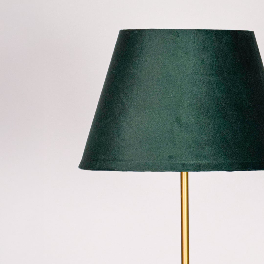 Closeup green fabric tapered shade with smooth texture designed for soft ambient lighting in modern living room Decor.