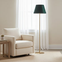 Modern gold metal floor lamp with green fabric shade placed beside armchair in bright living room for ambient lighting Decor.