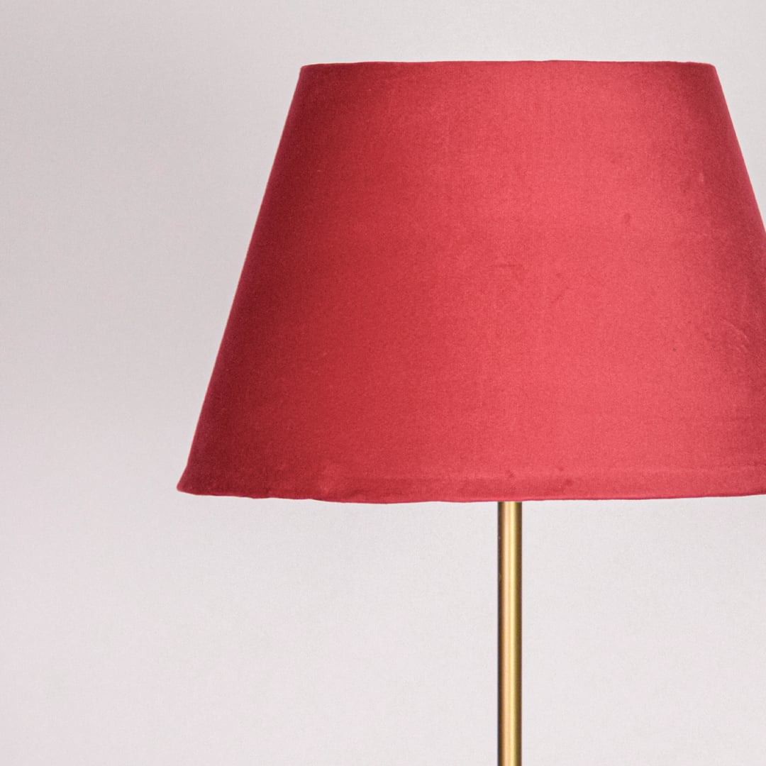 Closeup red fabric tapered shade with rich color finish ideal for warm accent lighting in stylish home interior Decor.
