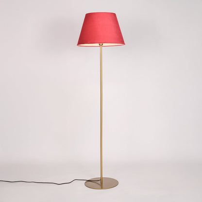 Gold metal floor lamp with red fabric shade illuminated on white background for cozy accent bedroom lighting Decor.