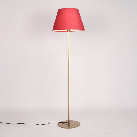 Gold metal floor lamp with red fabric shade illuminated on white background for cozy accent bedroom lighting Decor.