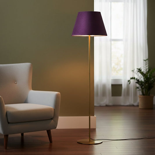 Modern gold metal floor lamp with purple fabric shade placed in living room corner for warm ambient lighting Decor.