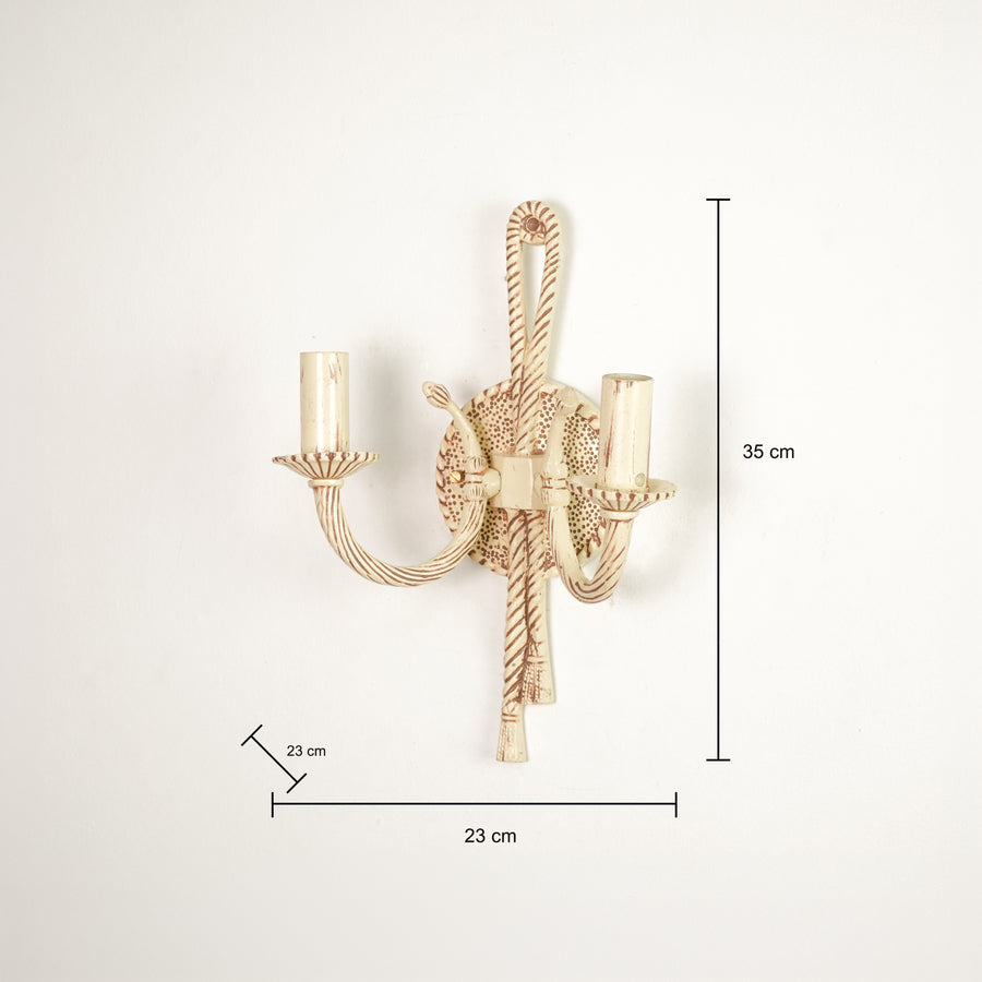 A wall-mounted two-light candle-style sconce in a warm gold finish, shown with dimension lines and labels indicating a height of 35 cm, width of 23 cm, and candle-tip spacing of 23 cm against a plain white background.