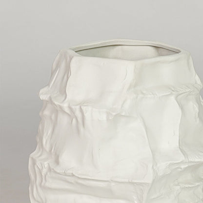Textured white ceramic flower vase closeup modern decorative vase for shelf console table living room home decor styling.