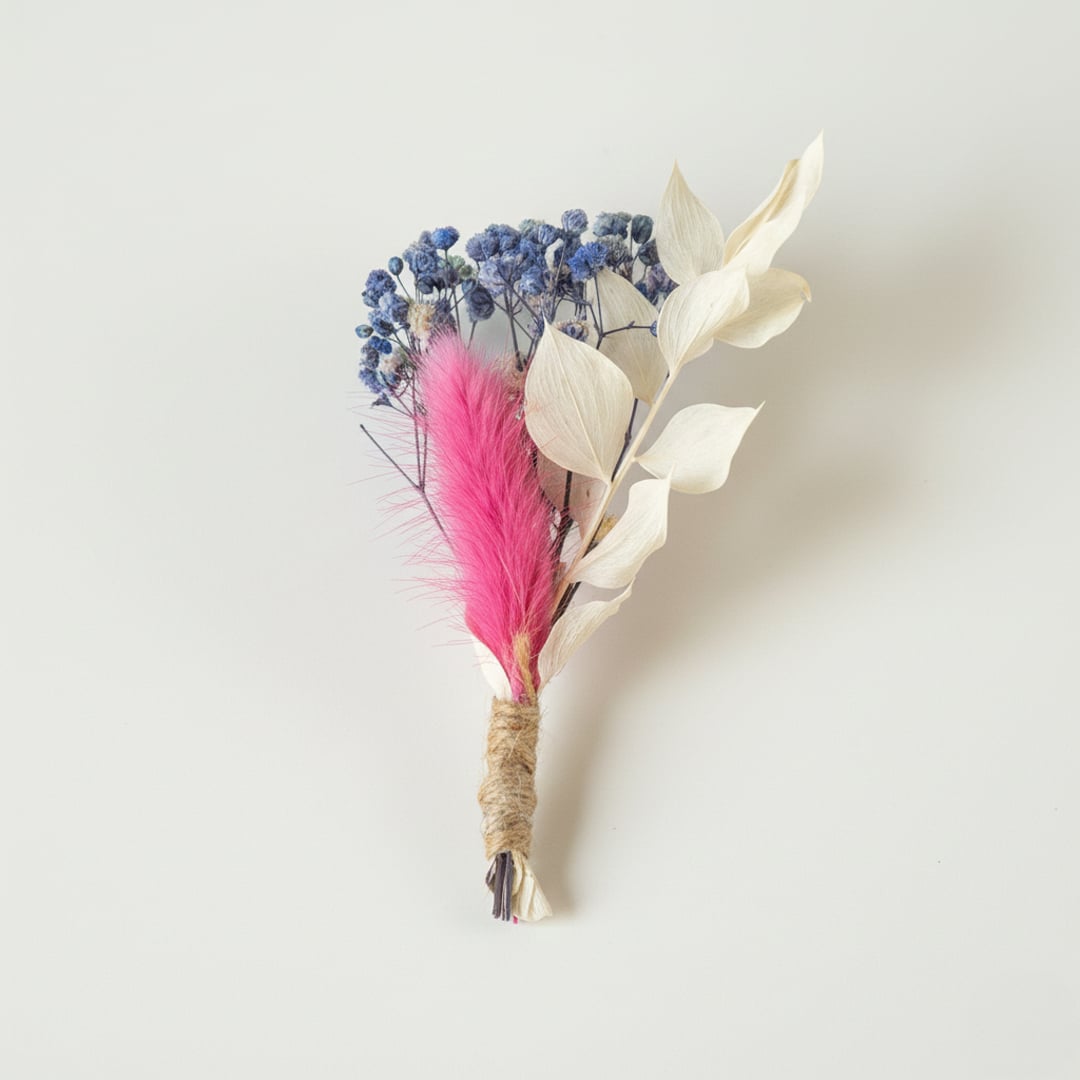 Dried floral stem bouquet with blue blossoms ivory leaves and pink accent on white background showcasing soft textures handcrafted decor elegance.