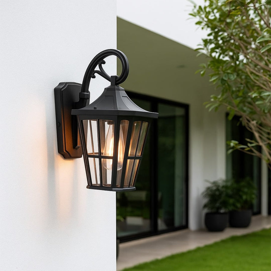 Elegant black metal outdoor wall lantern mounted on a modern exterior wall adding warm ambient lighting for garden and patio decor.