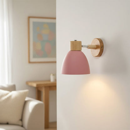 Modern pink wall light with wooden accents creating cozy ambient bedroom lighting decor.