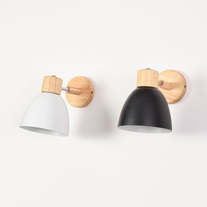 Grouped wall mounted lights with metal shades switched off showcasing color contrast wood detailing and cohesive modern style.