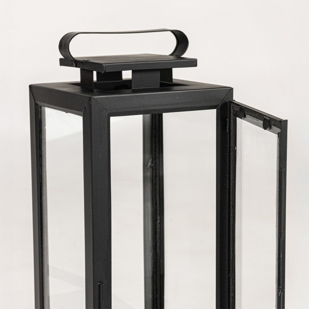 Closeup of black metal lantern top handle showing clean lines sturdy frame and modern decorative lighting craftsmanship.