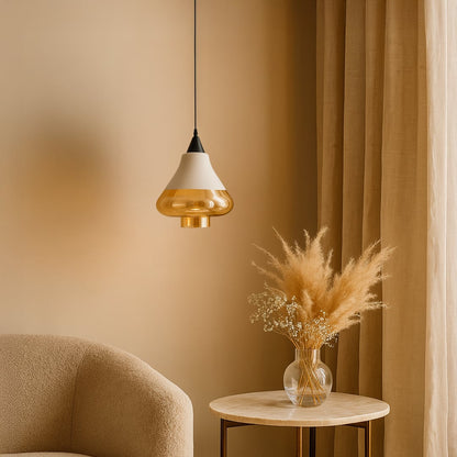 Amber glass pendant light glowing warmly in a beige-toned living room with a round table and dried pampas arrangement.