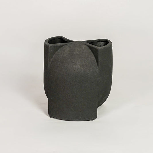 Contemporary black ceramic flower vase with artistic folded silhouette perfect for entryway table living room decor display.