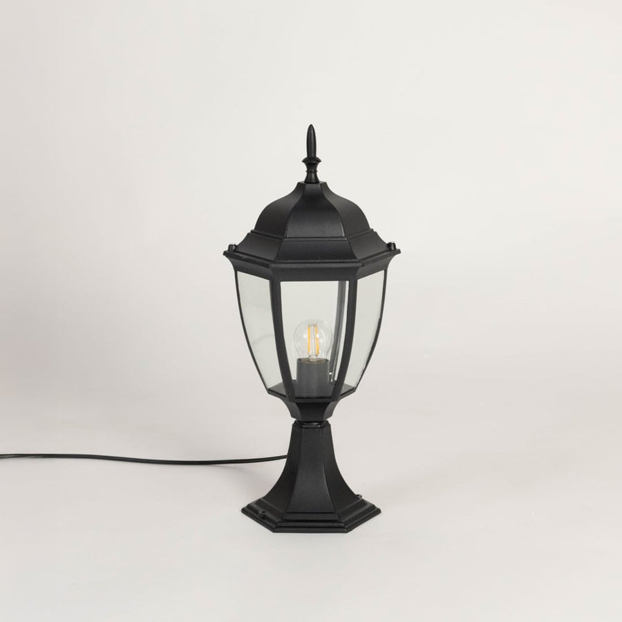 Classic black outdoor pillar lamp with clear glass panels ideal for modern garden patio balcony and driveway lighting.