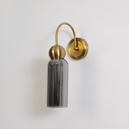 Gold metal wall light with smoked grey glass shade shown on a white background for clear product detailing.