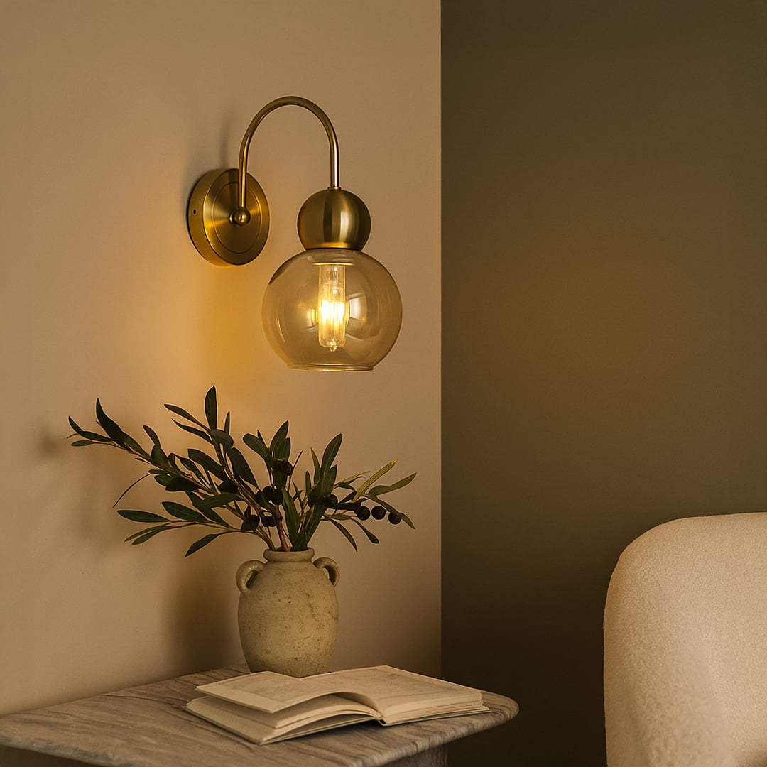 Amber glass wall light with gold metal mount adding cozy decorative lighting to a stylish living space.