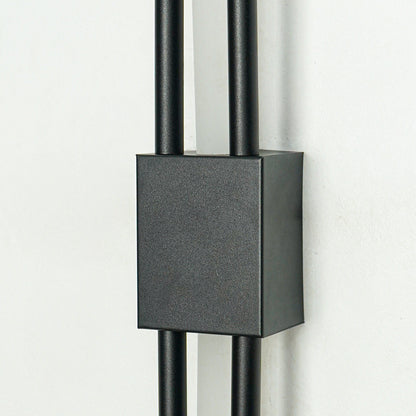 Closeup of textured black metal wall light with sleek dual rods for luxury hallway bedroom and living room interiors.