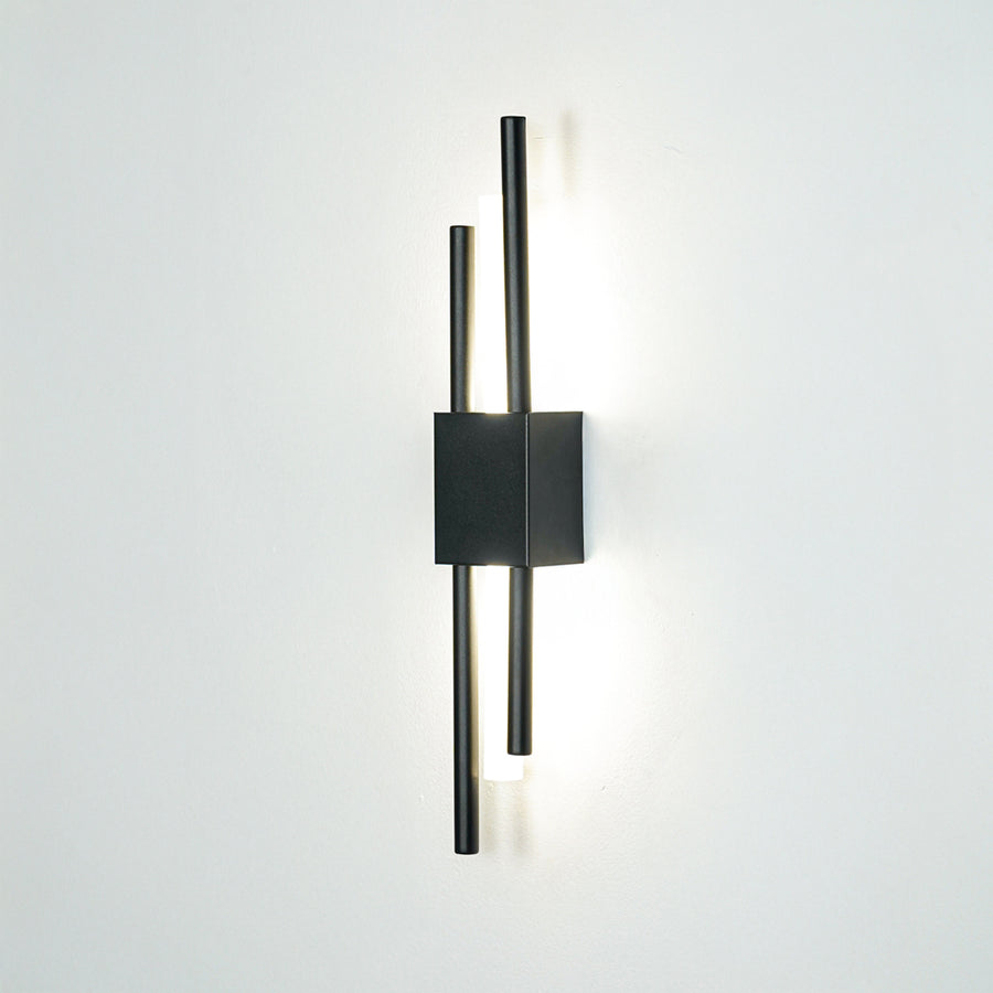 Contemporary black metal wall light with dual linear rods mounted on white background for modern interior lighting decor.