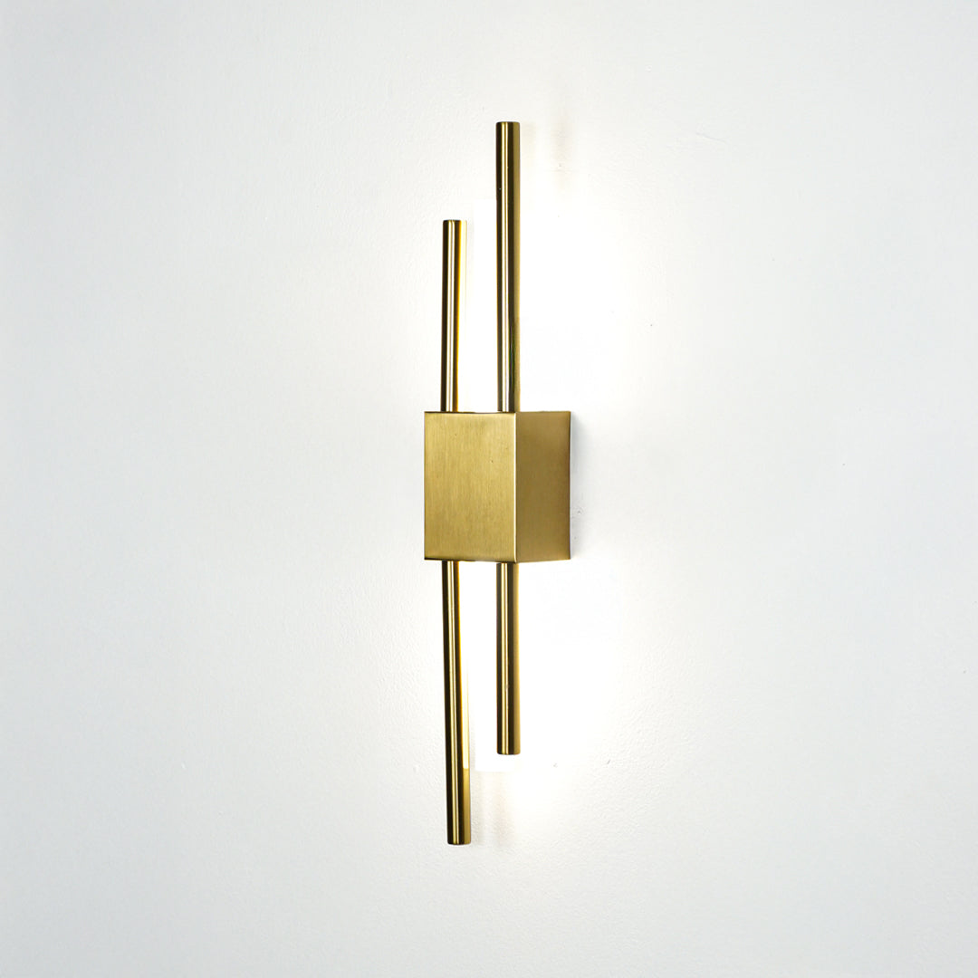 Elegant gold metal wall light glowing on white wall for modern bedroom hallway and luxury interior decor styling.