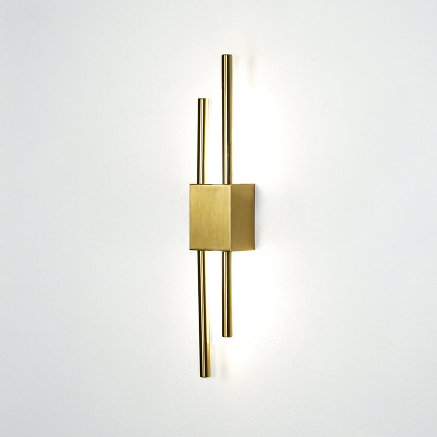 Elegant gold metal wall light glowing on white wall for modern bedroom hallway and luxury interior decor styling.
