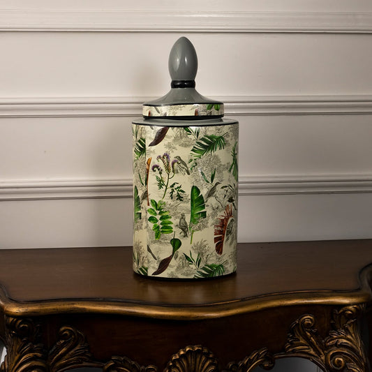 Tropical leaf jar on a white background showcasing its detailed leaf artwork and glossy ceramic body.