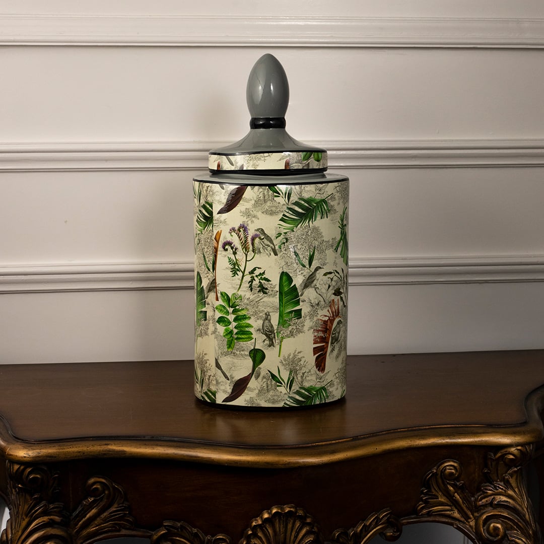 Tropical leaf jar on a white background showcasing its detailed leaf artwork and glossy ceramic body.