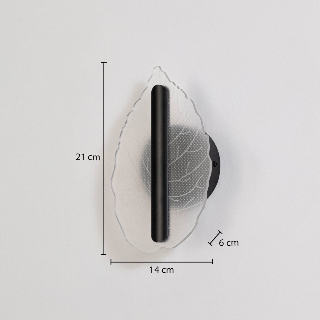 Black wall light with leaf shaped acrylic shade shown with 21 cm height and 14 cm width for accurate sizing.
