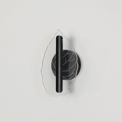 Black wall light with leaf shaped acrylic shade shown on a bright white background with lights off for product clarity.