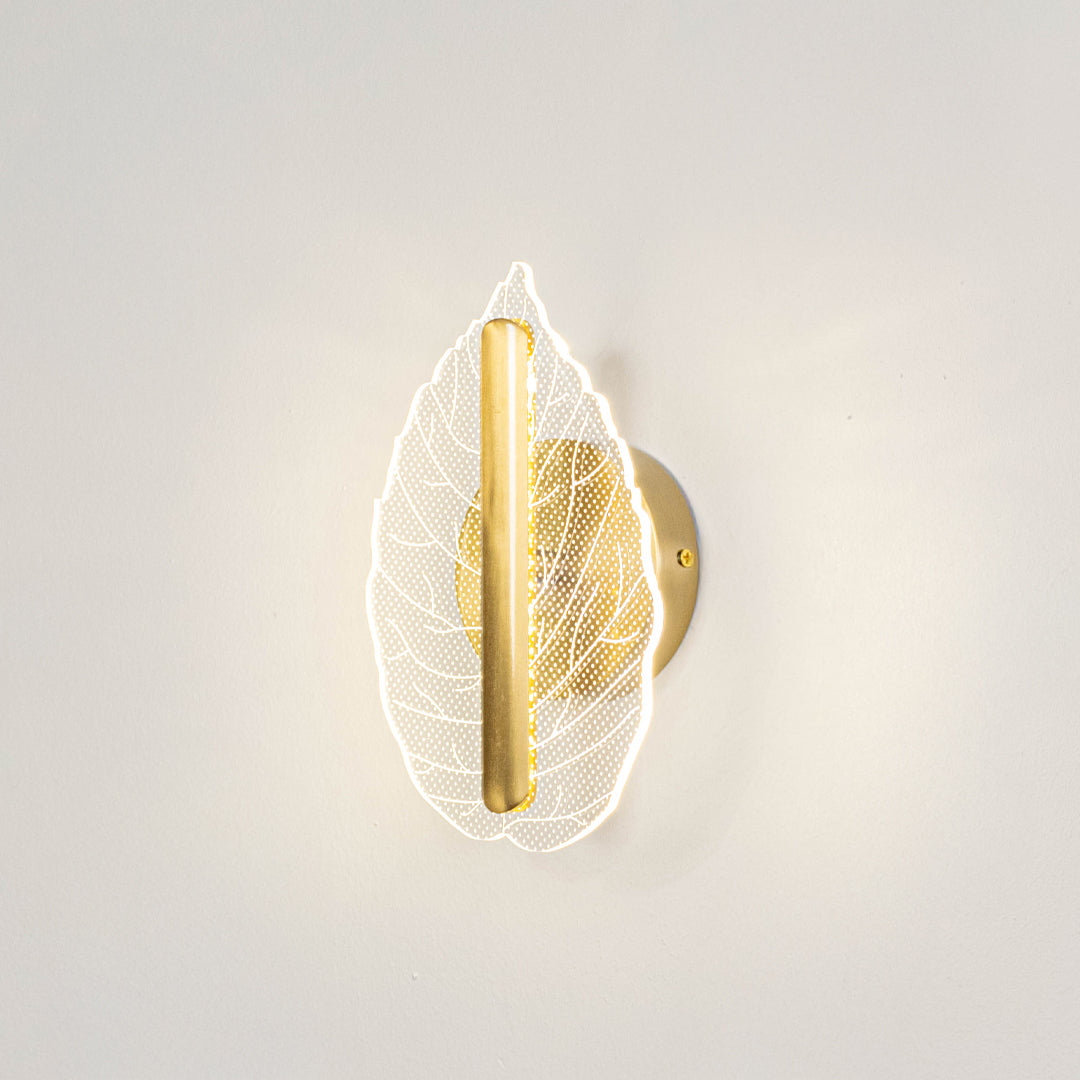 Modern decorative wall light with leaf design and warm glow for bedroom or living decor lighting placement white background.