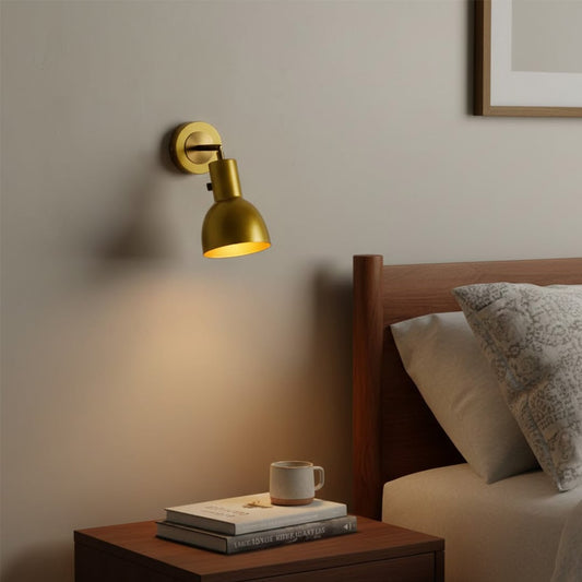 Modern gold metal bedside wall light with warm glow for elegant bedroom and luxury decor styling spaces.