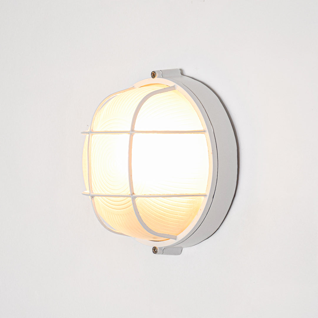 White metal wall light for modern bedroom placement and stylish indoor lighting decor accent with warm glow.