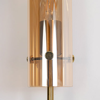 Detailed view of black modern wall sconce with cylindrical glass shade elegant finish ideal for bedroom hallway and living space.